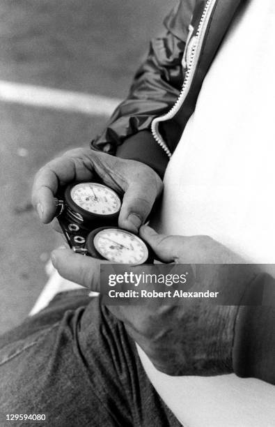 Race car owner Junior Johnson uses a stopwatch to check the speeds of cars at the Daytona International Speedway as they attempt to qualify for the...