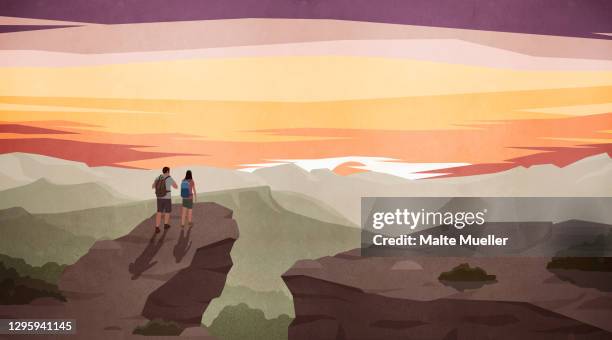 couple hiking and enjoying scenic majestic mountain view at sunset - backpacker travel stock-grafiken, -clipart, -cartoons und -symbole