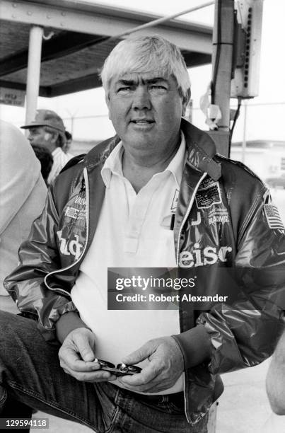 Race car owner Junior Johnson uses a stopwatch to check the speeds of cars at the Daytona International Speedway as they attempt to qualify for the...