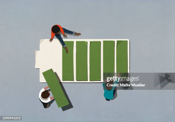 stockillustraties, clipart, cartoons en iconen met friends assembling green battery - batterij