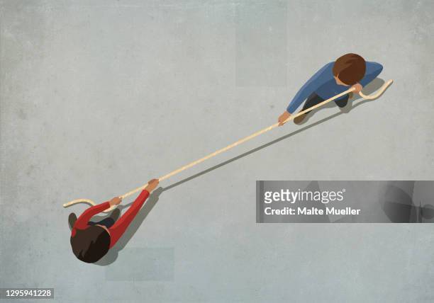 couple engaging in tug of war with rope - konflikt stock-grafiken, -clipart, -cartoons und -symbole