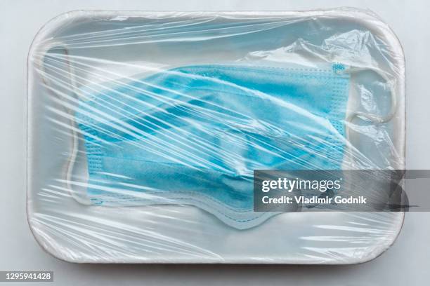 face mask under plastic wrap on tray - cellophane stock pictures, royalty-free photos & images