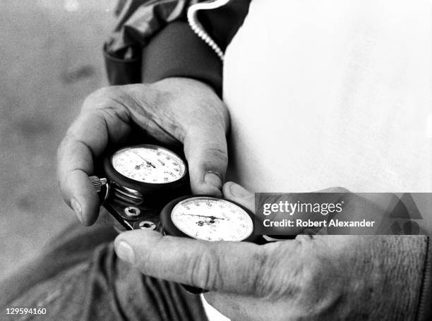 Race car owner Junior Johnson uses a stopwatch to check the speeds of cars at the Daytona International Speedway as they attempt to qualify for the...