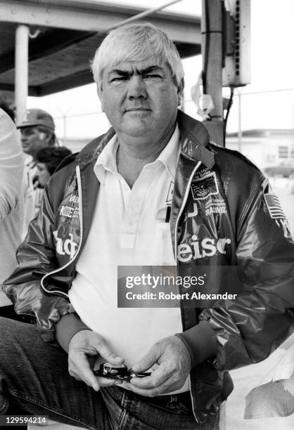 Race car owner Junior Johnson uses a stopwatch to check the speeds of cars at the Daytona International Speedway as they attempt to qualify for the...