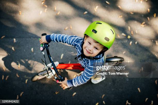 aerial view of young boy riding red bike - bicycle safety light stockfoto's en -beelden