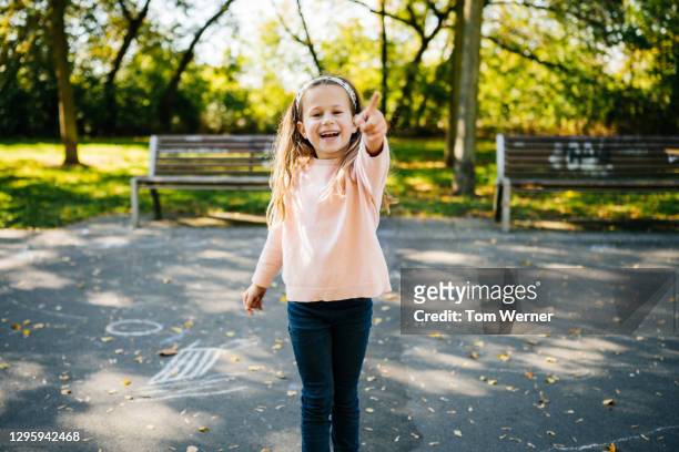 young girl pointing while hanging out in park - girl pointing bildbanksfoton och bilder