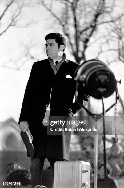 Television newsman Dan Rather broadcasts from outside the National Cathedral in Washington, D.C., during the funeral for former president Dwight...