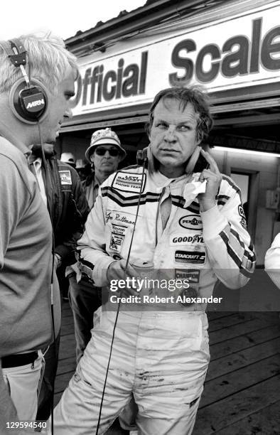 Driver Joe Ruttman talks with a Motor Racing Network radio broadcaster in the Daytona International Speedway garage area after the conclusion of the...