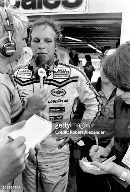 Driver Joe Ruttman talks with a Motor Racing Network radio broadcaster in the Daytona International Speedway garage area after the conclusion of the...