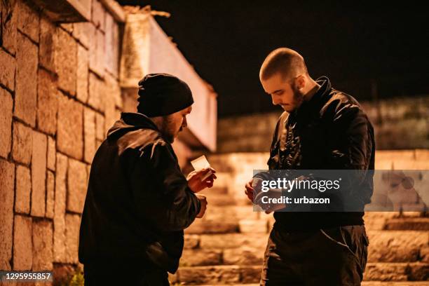 man buying drugs on the street - drug dealer stock pictures, royalty-free photos & images