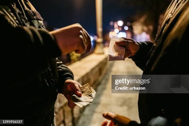 man buying drugs on the street - deadly exchange stock pictures, royalty-free photos & images