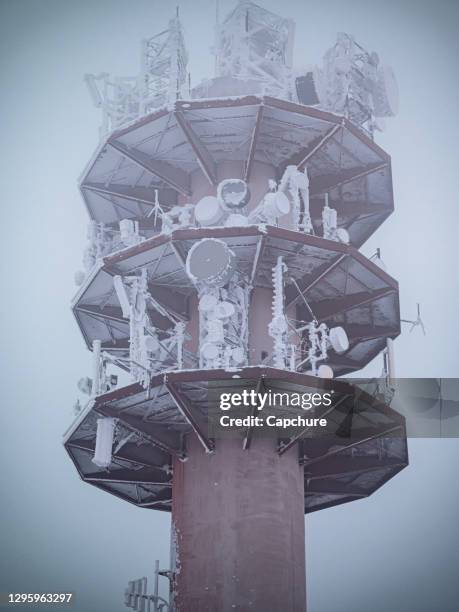 a frozen disused radio tower covered in fresh snow. - geisterstadt stock-fotos und bilder