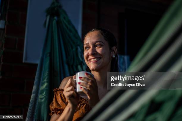 relaxed young woman having a cup of coffee - free images without copyright stock pictures, royalty-free photos & images