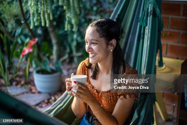 relaxed young woman having a cup of coffee - images royalty free stock pictures, royalty-free photos & images