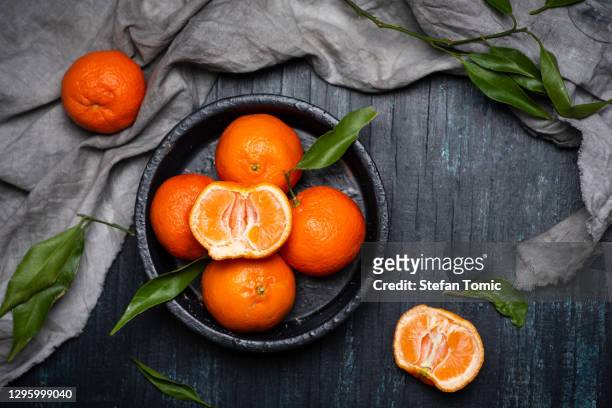 tangerine orange fruit on a plate top view - tangerine stock pictures, royalty-free photos & images