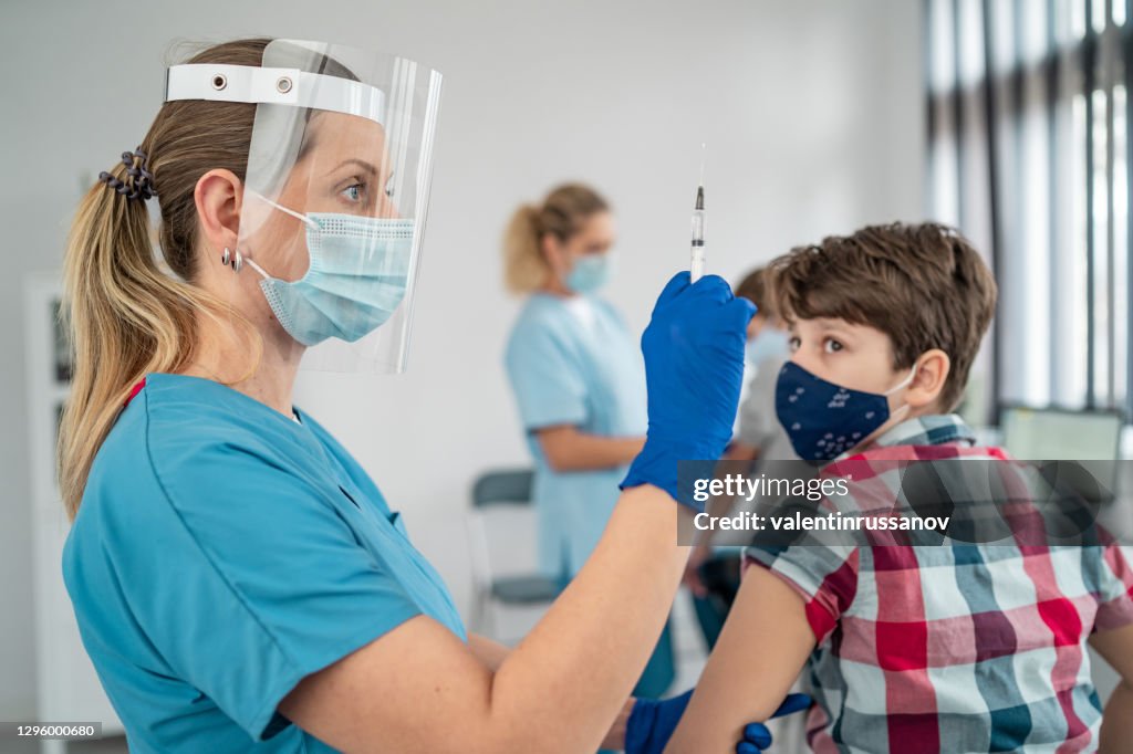 Vaccinating Doctor Vaccinating Boy Injecting Covid19 Vaccine Into Patients Arm High ...