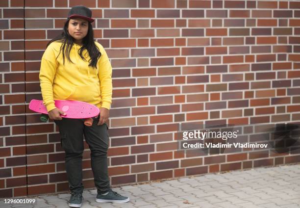 street portrait of skate girl - sad girl standing stock pictures, royalty-free photos & images