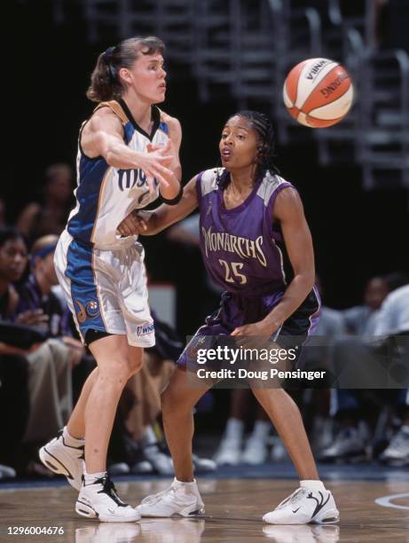 Coco Miller, Guard for the Washington Mystics passes the basketball as she is challenged by Kedra Holland-Corn of the Sacramento Monarchs during...