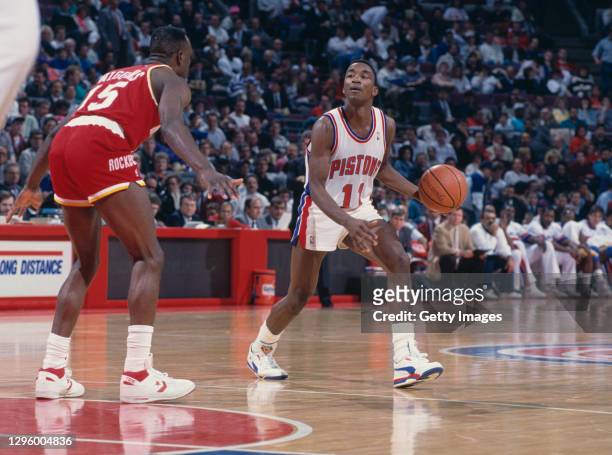 Isiah Thomas, Point Guard for the Detroit Pistons dribbles the basketball as Mitchell Wiggins, Shooting Guard for the Houston Rockets faces to block...