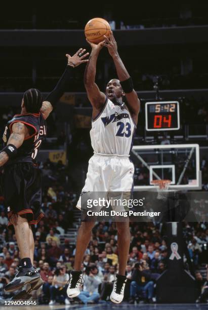 Michael Jordan for the Washington Wizards makes a jump shot as Allen Iverson of the Philadelphia 76ers reaches to block during their NBA Atlantic...