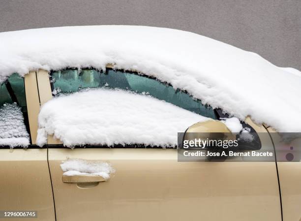 car parked on the street covered with snow. - parked cars stock pictures, royalty-free photos & images