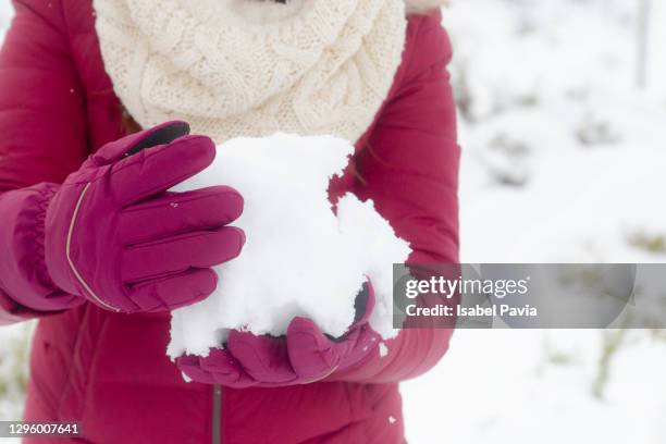 close-up of hands in mittens holding snowball - woman hands in mittens stock-fotos und bilder