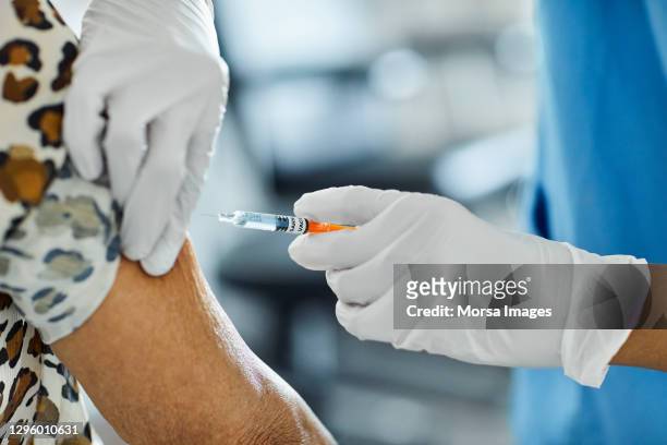 spanish hospital administers some of the country's first covid-19 vaccination shots - covid 19 vaccine stock pictures, royalty-free photos & images