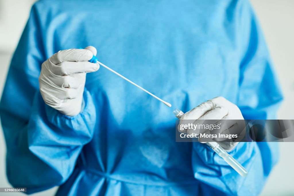 Doctor/Nurse with Swab Test Sample in Hospital, PCR Device