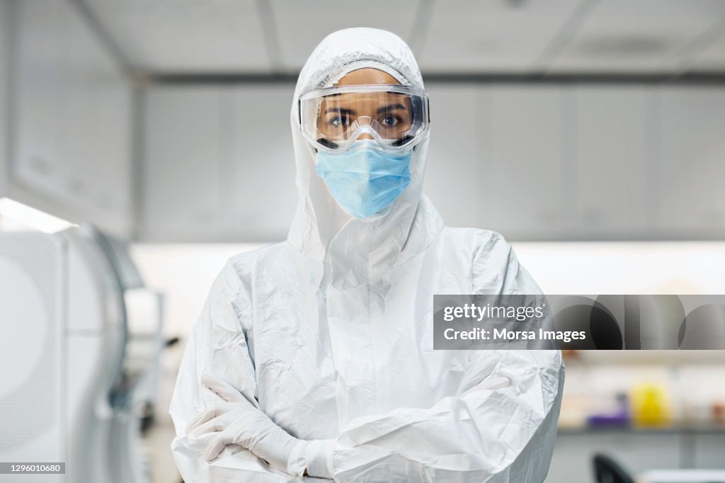 Confident doctor in protective suit at laboratory