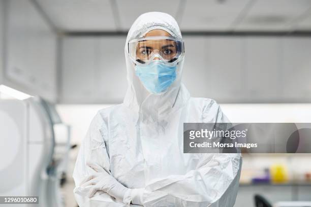 confident doctor in protective suit at laboratory - abbigliamento da lavoro foto e immagini stock