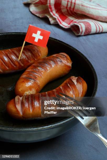 fried cervelat in pan, switzerland - cervelat stock-fotos und bilder