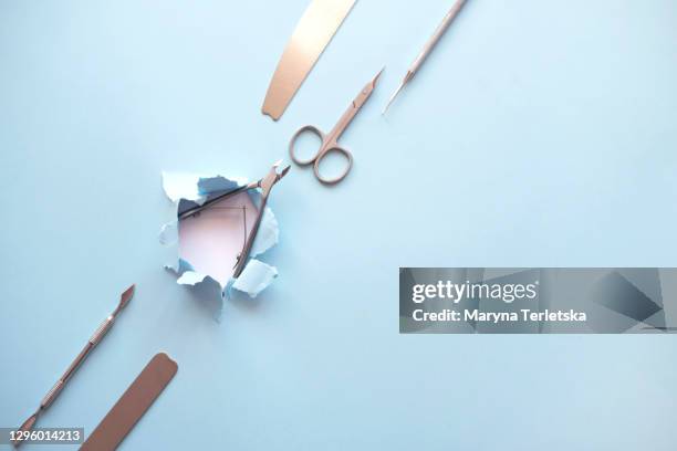 set for manicure with metal on a blue background. - nail file stock pictures, royalty-free photos & images