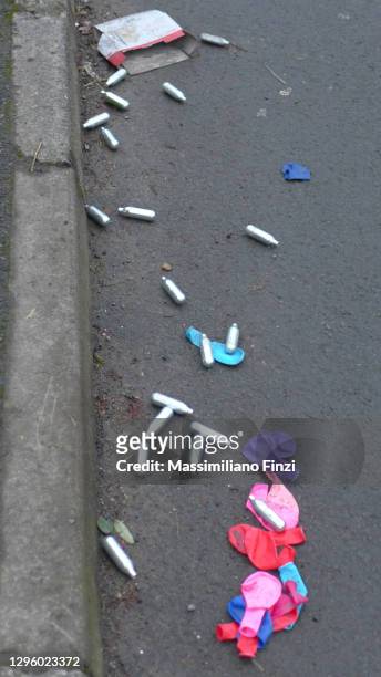 nitrous oxide n2o canisters litter in downend, bristol streets after being used as a recreational drug - bristol balloons stock pictures, royalty-free photos & images