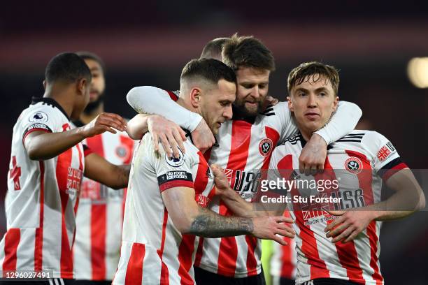 Billy Sharp of Sheffield United celebrates with Oliver Norwood and Ben Osborn after scoring a penalty for his side's first goal during the Premier...