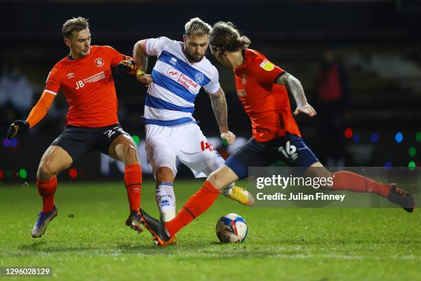 Charlie Austin of Queens Park Rangers shoots while under pressure from Kiernan Dewsbury-Hall and Glen Rea of Luton Town during the Sky Bet...