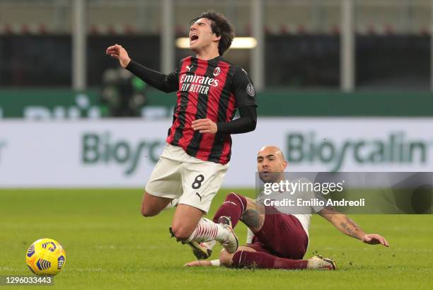 Sandro Tonali of AC Milan is challenged by Simone Zaza of Torino FC during the Coppa Italia match between AC Milan and Torino FC at Stadio Giuseppe...