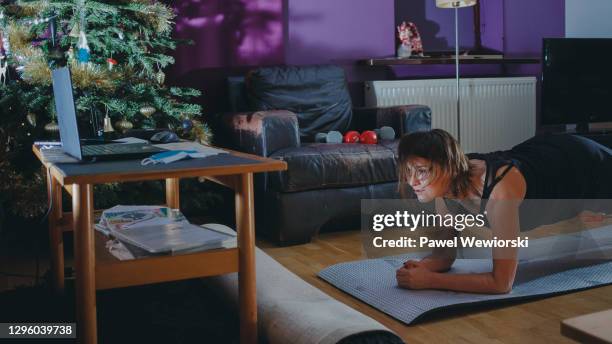 woman exercising - daily life during christmas season in poland foto e immagini stock