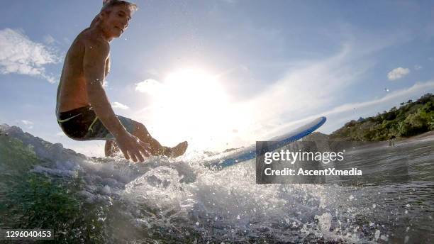 pov view of man learning to surf in the morning - shorts down stock pictures, royalty-free photos & images