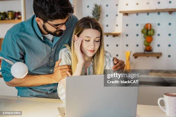 young man encourages his girlfriend who is having a stressful day working from home - boyfriend stock pictures, royalty-free photos & images