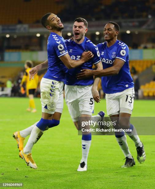 Michael Keane of Everton celebrates with Mason Holgate and Yerry Mina after scoring their team's second goal during the Premier League match between...