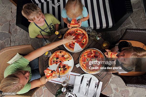 childrens eating pizza - prague cafe stock pictures, royalty-free photos & images