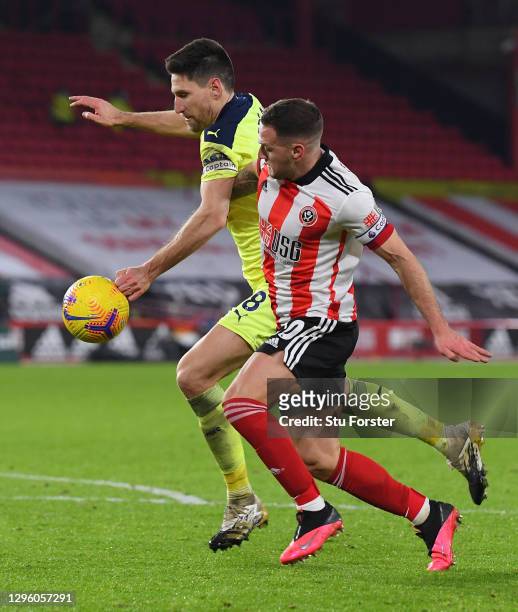 Billy Sharp of Sheffield United battles for possession as the ball hits the arm of Federico Fernandez of Newcastle United leading to a penalty during...