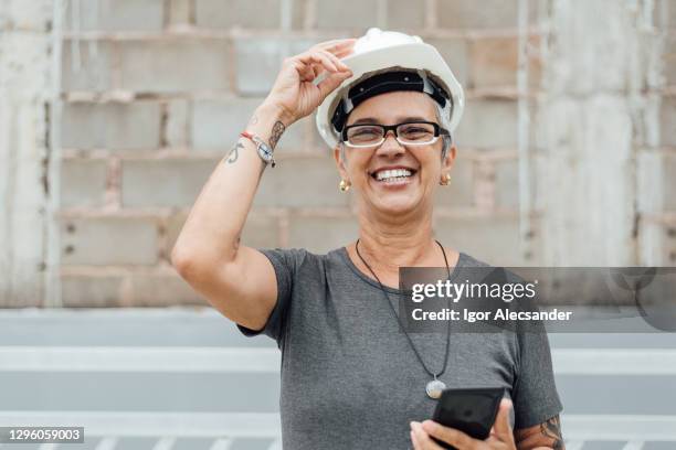 smiling senior engineer woman at work - old woman tattoos stock pictures, royalty-free photos & images