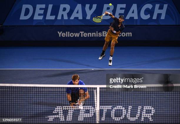 Christian Harrison serves against Hugo Nys of Monaco and Andrés Molteni of Argentina while playing with his brother Ryan Harrison during the Doubles...