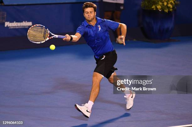Ryan Harrison returns a shot against Hugo Nys of Monaco and Andrés Molteni of Argentina while playing with his brother Christian Harrison during the...