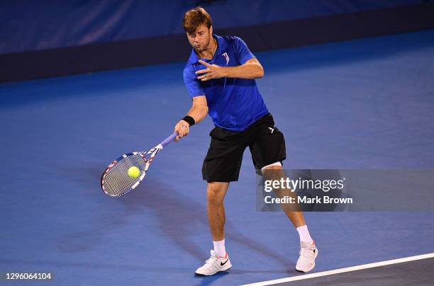 Ryan Harrison returns a shot against Hugo Nys of Monaco and Andrés Molteni of Argentina while playing with his brother Christian Harrison during the...