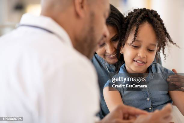 mother and daughter at doctor's office - child diabetes stock pictures, royalty-free photos & images