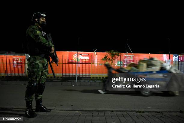 Soldier from the Military Police stands guard during a military patrol amidst the night curfew on January 12, 2021 in Bogota, Colombia. Mayor of...