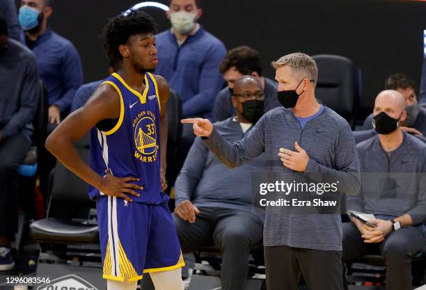 Head coach Steve Kerr speaks to James Wiseman of the Golden State Warriors after he picked up his fourth foul in their game against the Indiana...