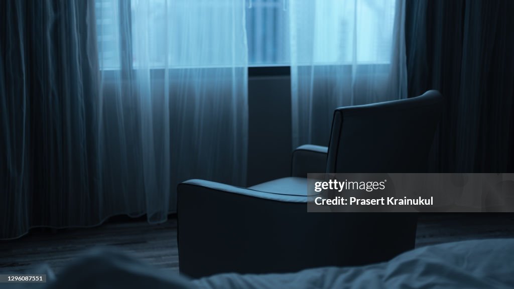 Empty armchair with window in the room, night time.